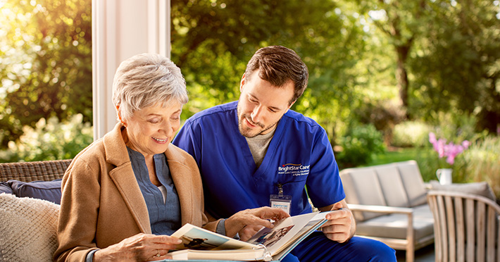 Home Health worker reading with elderly woman